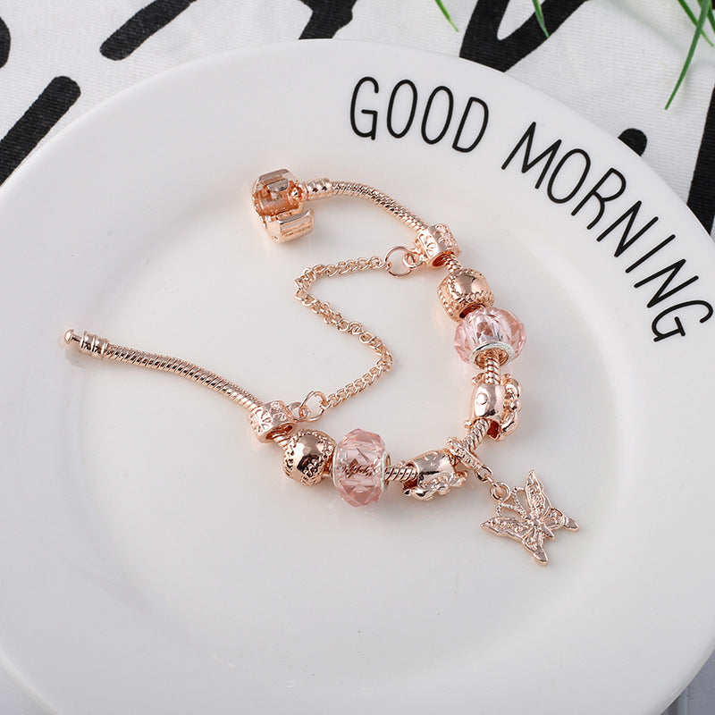 Close-up of rose gold-toned geometric heart bracelet detail