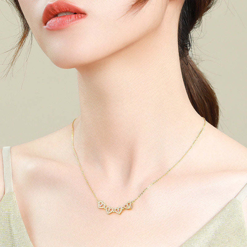 Woman wearing heart clover choker necklace at collarbone