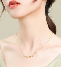 Woman wearing heart clover choker necklace at collarbone