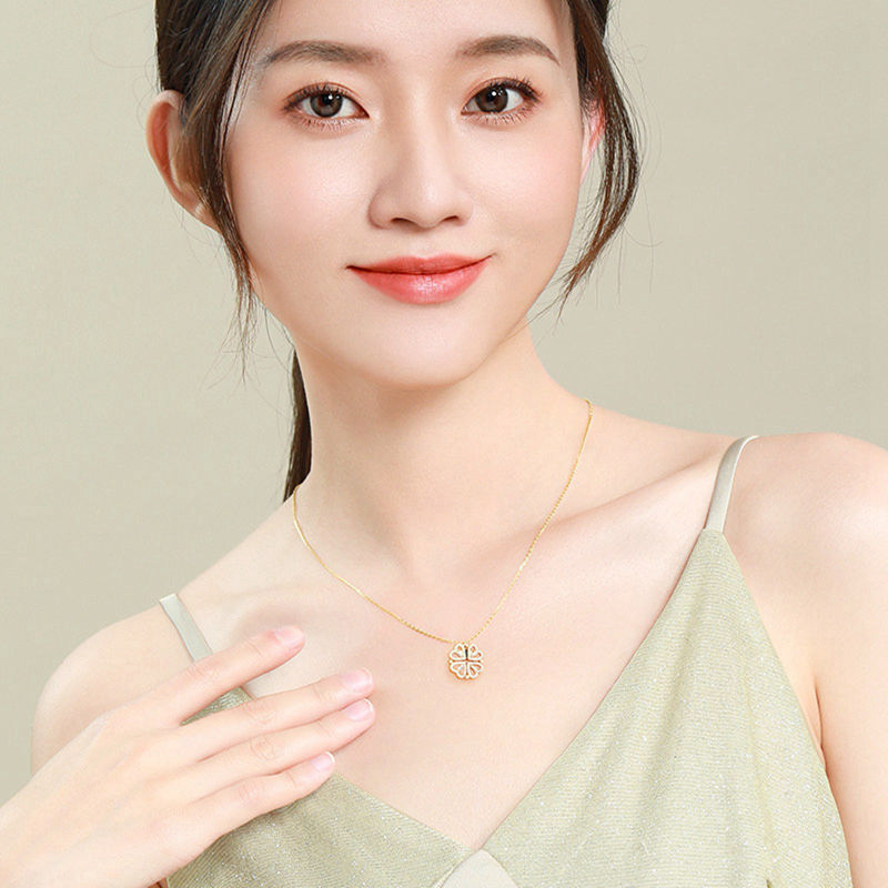 Woman wearing heart clover choker necklace at collarbone