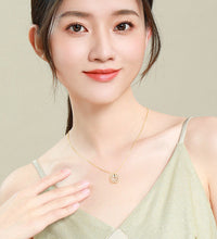 Woman wearing heart clover choker necklace at collarbone